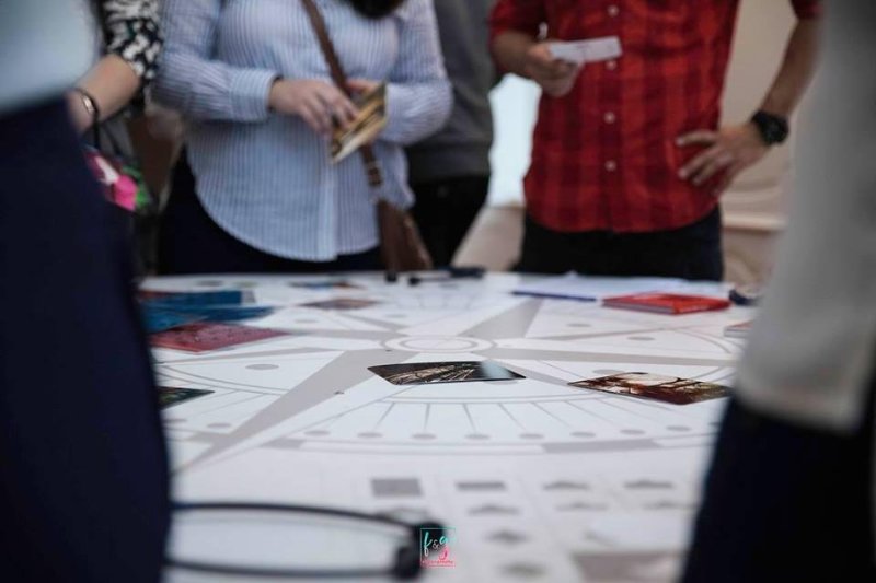 photos on a table and people around