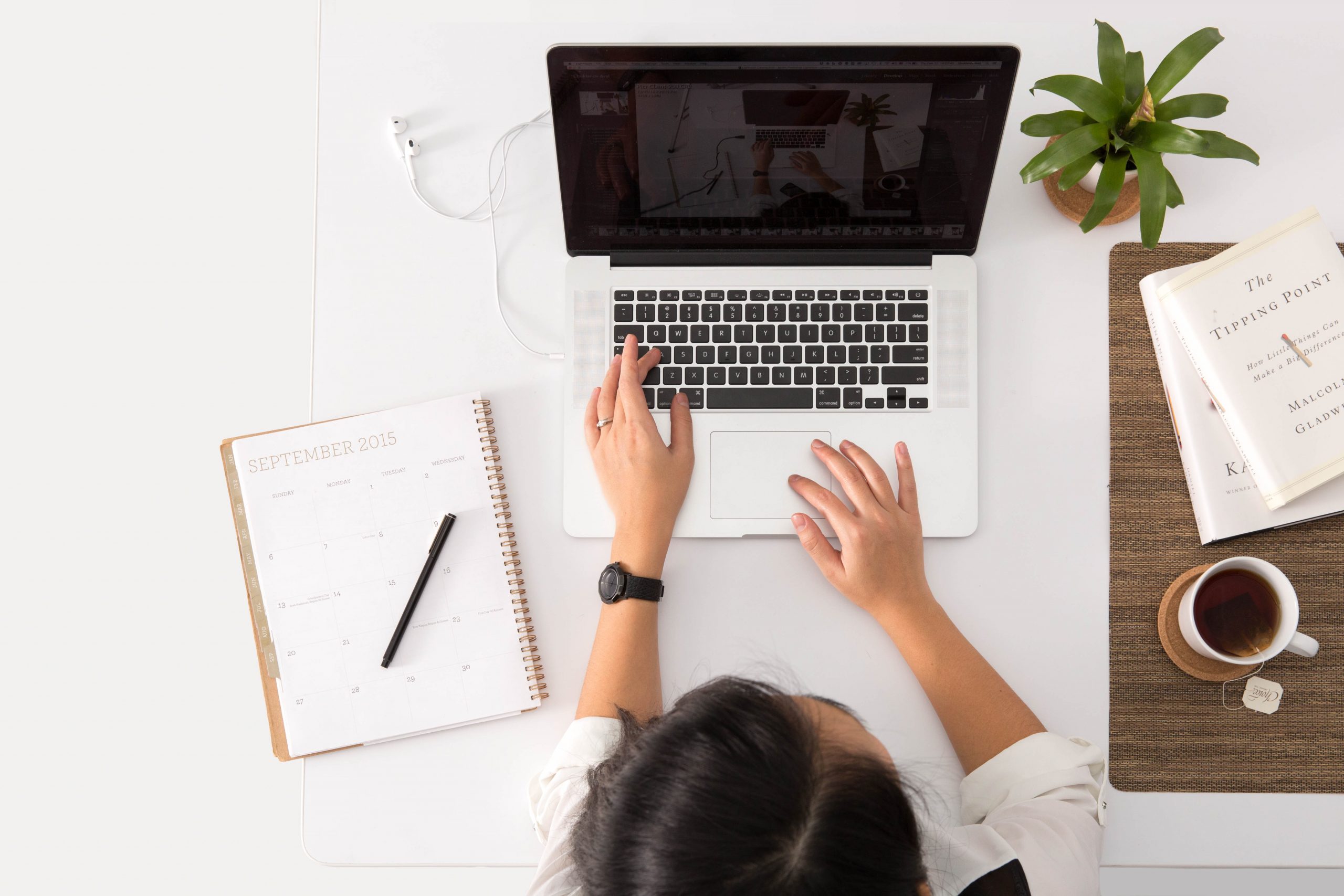 person with laptop and notebook